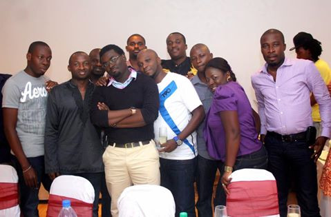 Command Ojo classmates gathered indoors at a celebration, smiling together